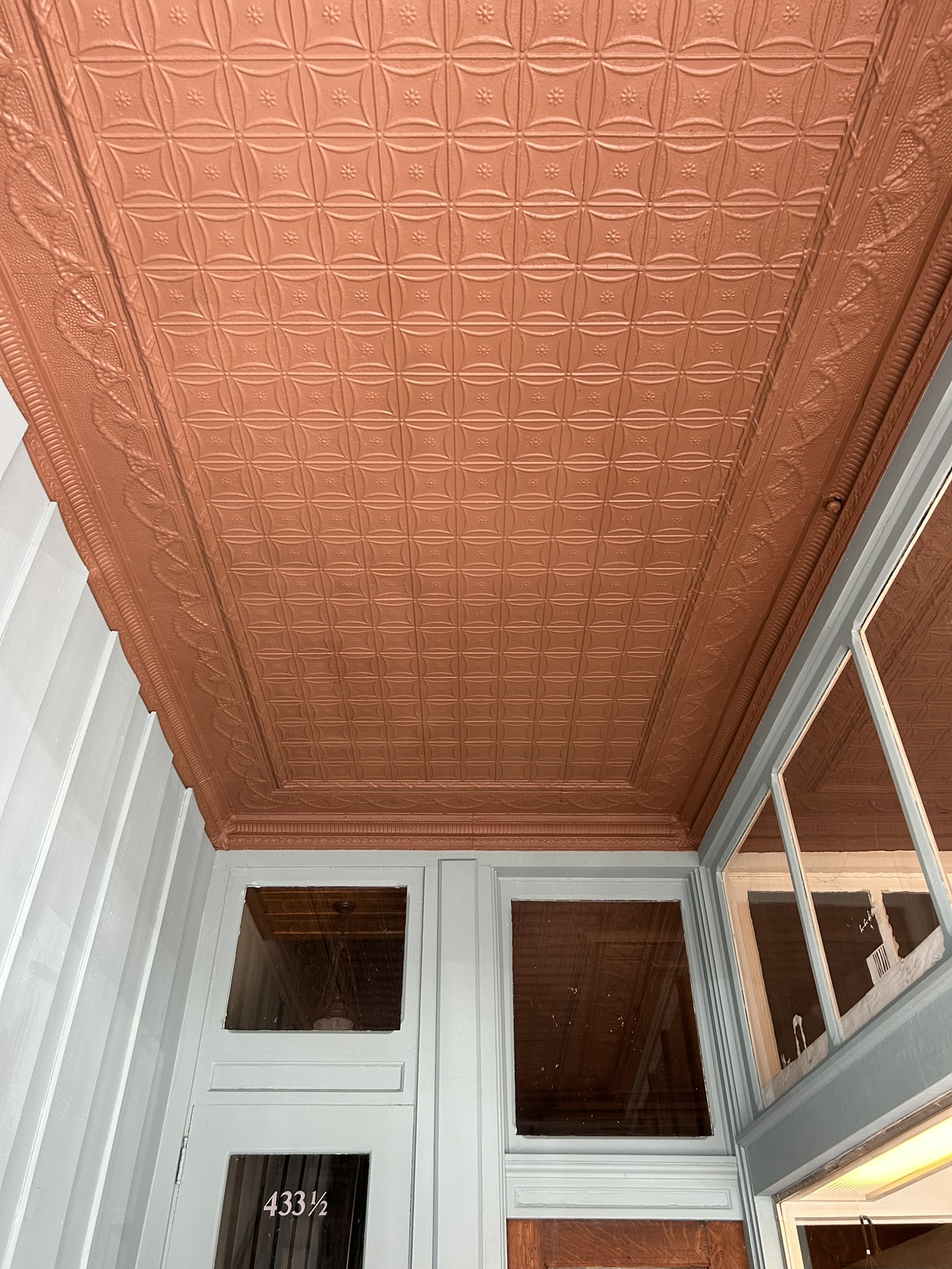 Refinished pressed-tin ceiling with light blue interior doors